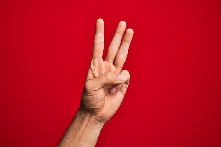 Three fingers on red background